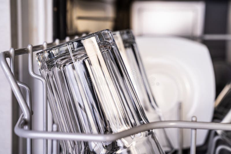Clean shiny transparent glasses in dishwasher royalty free stock photography