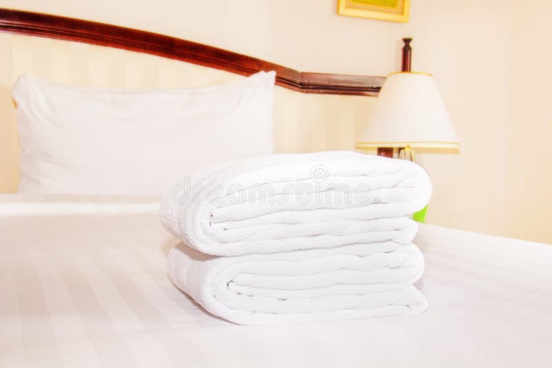 Clean towel on the bed stock photo. Image of interior 59588452