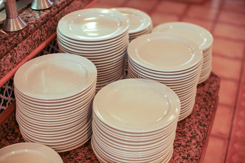 Clean White Plates Ready at Table in Buffet Restaurant Stock Photo