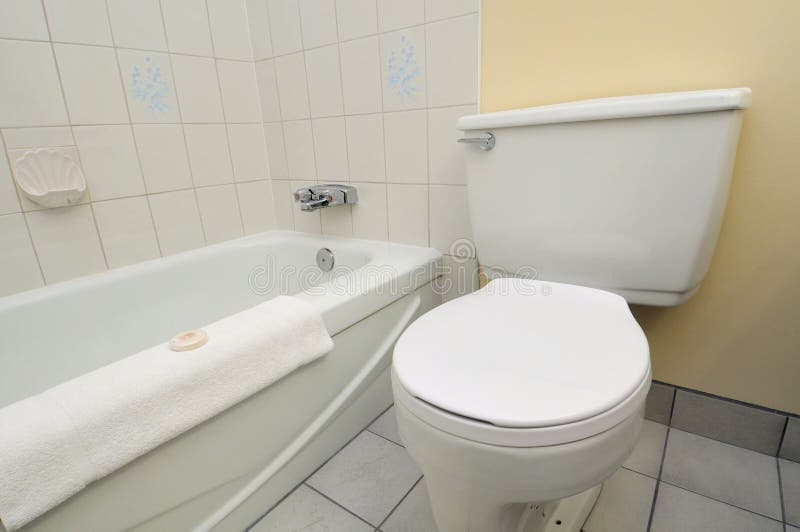 Clean white toilet and bathtub