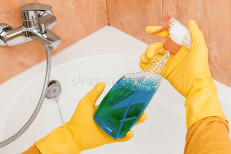 Cleaner Holds the Detergent from the Mold in the Bathroom Stock Photo