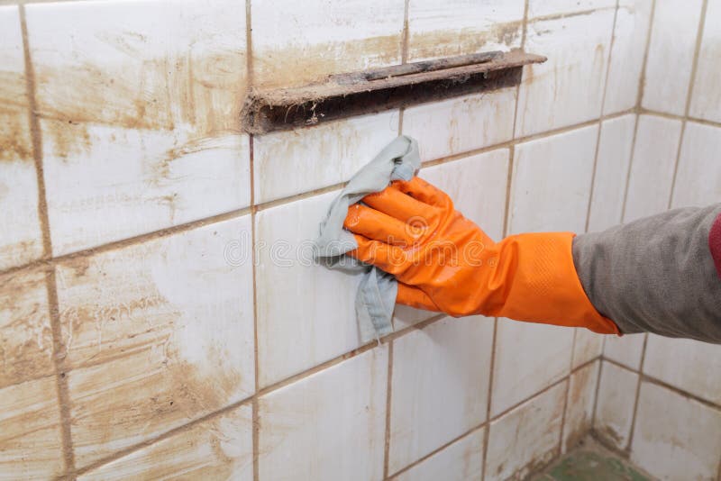 Cleaning of dirty old tiles in a bathroom