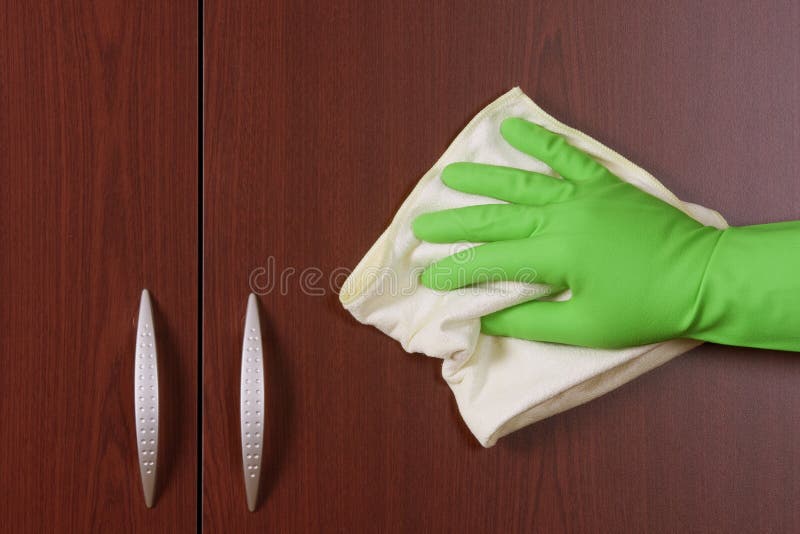 Cleaner hand polishing the door of closet. Cleaner hand polishing the door of closet