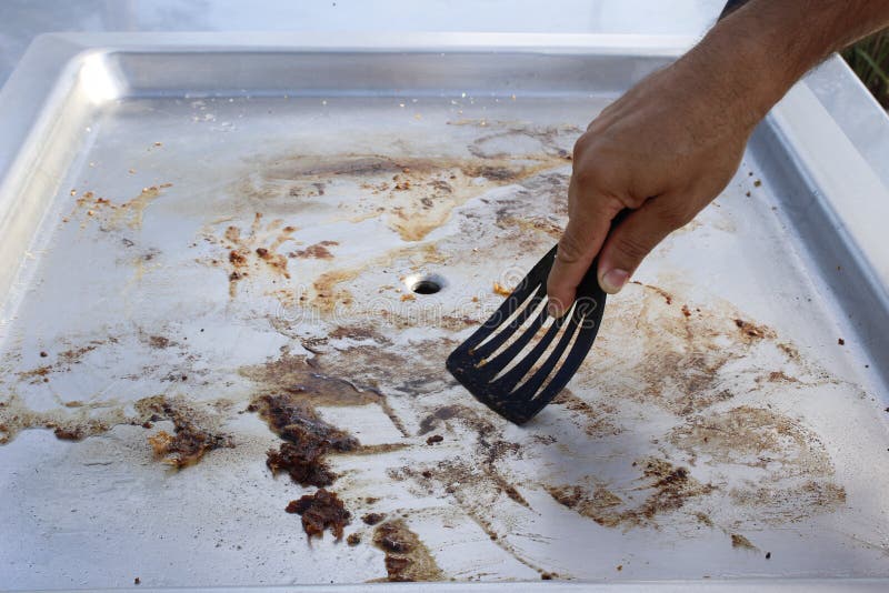 Cleaning the Barbeque Plate Stock Photo Image of plate, scraper 39887464