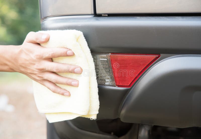 Cleaning Car with Microfiber Cloth Polishing Car the Back of Car Stock
