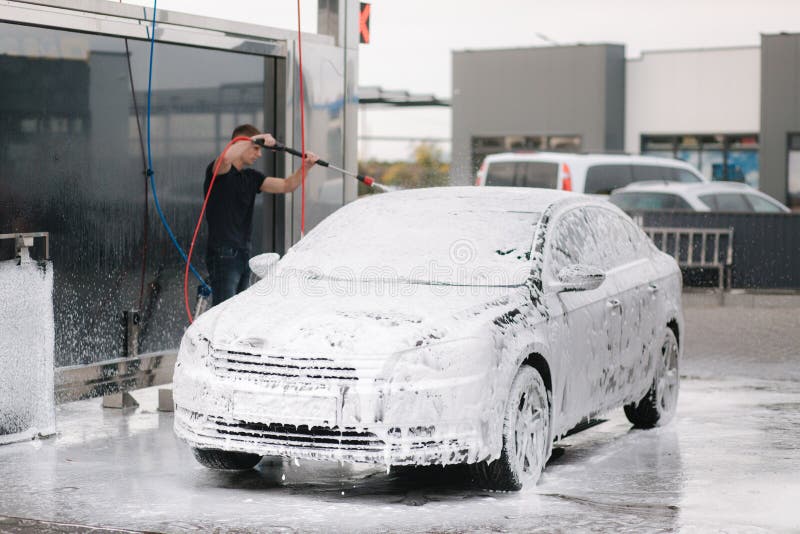 Cleaning Car Using Active Foam. Man Washing His Car on Self Carwashing