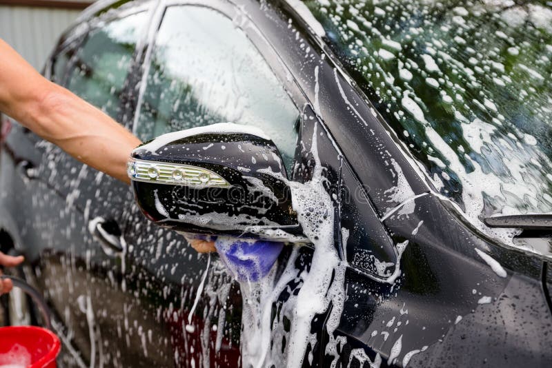 Cleaning automobile Using High Pressure Water. Man washing his car under high pressure water in service.worker washing stock image Cleaning automobile Using High Pressure Water. Man washing his car under high pressure water in service.worker washing stock image