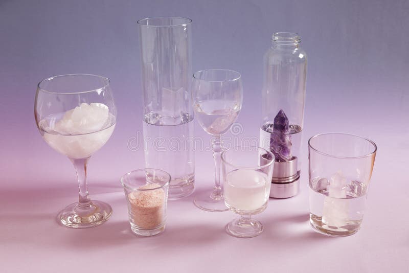 Cleaning and charging crystals with water and pink Himalayan salt stock photos