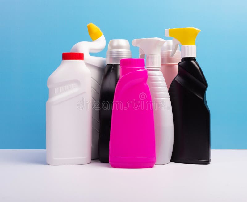 Cleaning Concept. Set of Cleaning Detergents in Colored Plastic Bottles