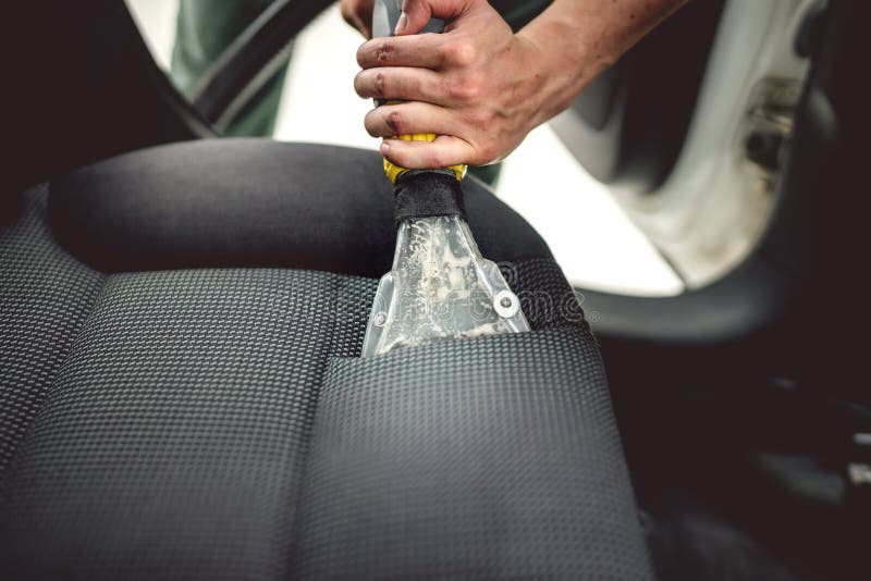 Cleaning interior of modern car. Details of upholstery vacuuming