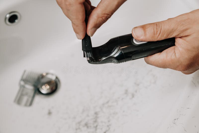 Trimmer Cleaning. Hands Brush Trimmer Head with Small Brush Stock Image