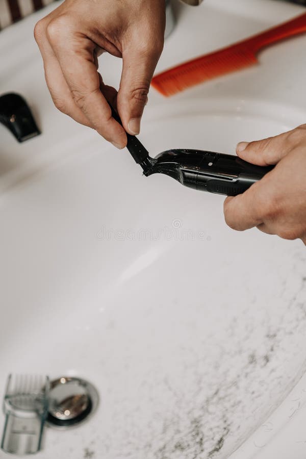 Trimmer Cleaning. Hands Brush Trimmer with Small Brush Stock Photo