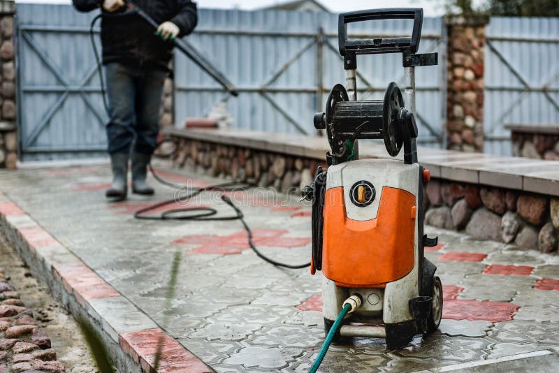 Cleaning Paving Slab Using High Pressure Power Washer Stock Image