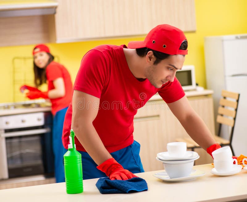 Cleaning Professional Contractors Working at Kitchen Stock Image