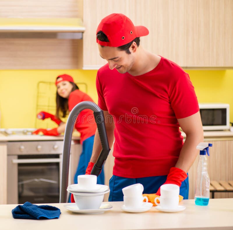 cleaning-professional-contractors-working-at-kitchen-stock-photo