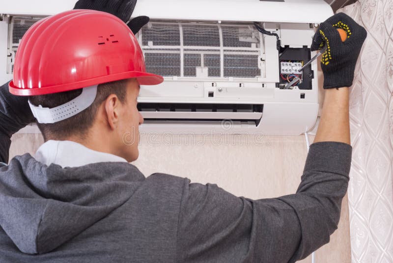 Repairman Working on Air Conditioner Stock Photo Image of tool