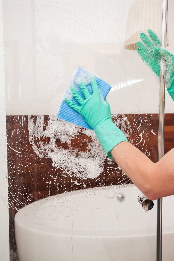 Cleaning a shower glass royalty free stock photography