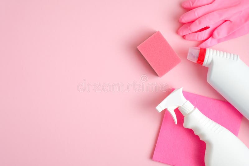 Cleaning supplies on pink background. Top view cleaner spray bottle, rag, sponge, detergent, rubber gloves. House cleaning service