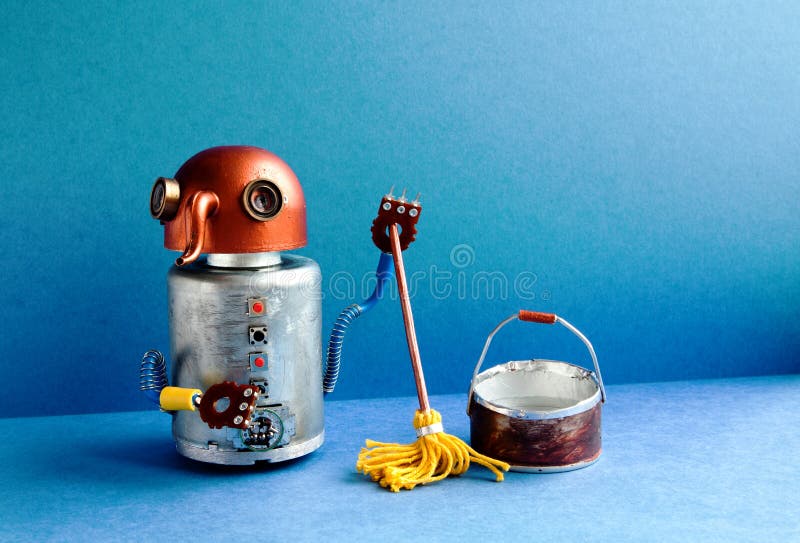 Cleaning washing room service concept. Funny robot janitor cleaner with yellow mop, bucket of water, sweeping floor. Creative design robotic toy cyborg in blue stock photo Cleaning washing room service concept. Funny robot janitor cleaner with yellow mop, bucket of water, sweeping floor. Creative design robotic toy cyborg in blue stock photo