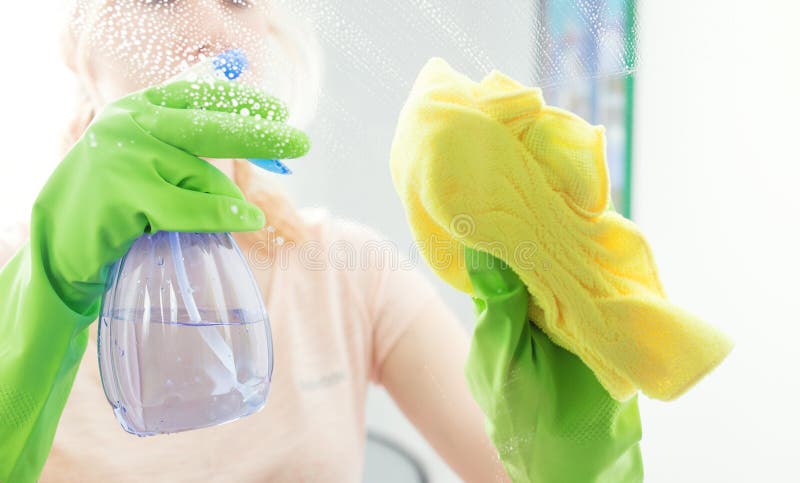 Cleaning window pane with detergent stock photo