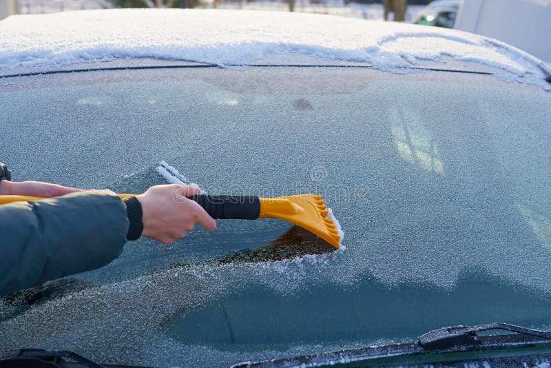 Cleaning the Windshield of the Car from the Ice Stock Photo Image of