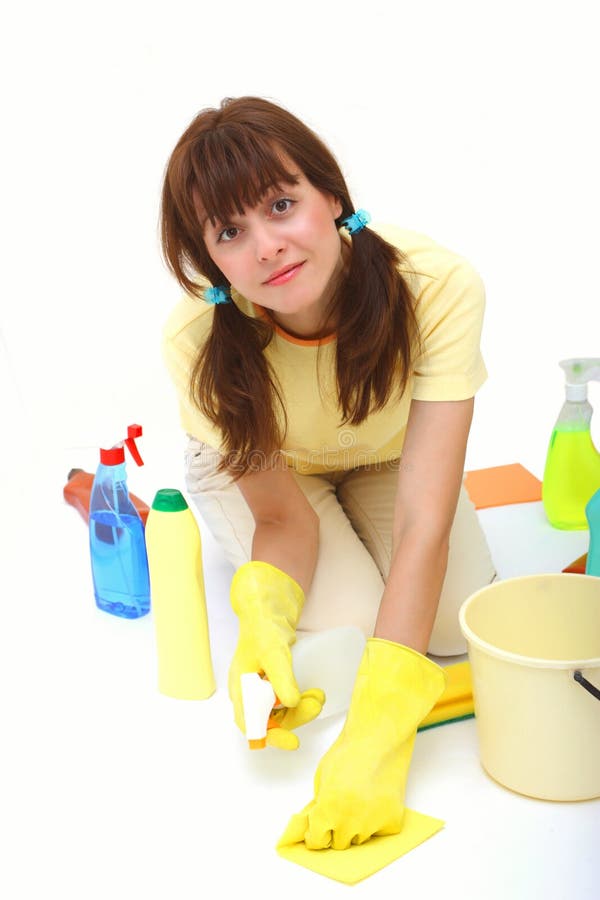 A woman cleaning floor with sponge and household chemistry isolated on a white background. A woman cleaning floor with sponge and household chemistry isolated on a white background