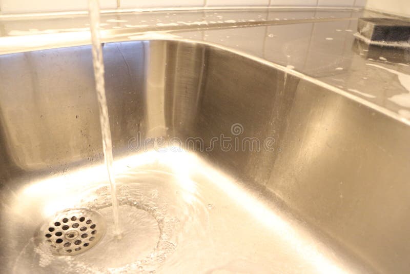 The cleansing of a stainless steel kitchen sink stock photography The cleansing of a stainless steel kitchen sink stock photography