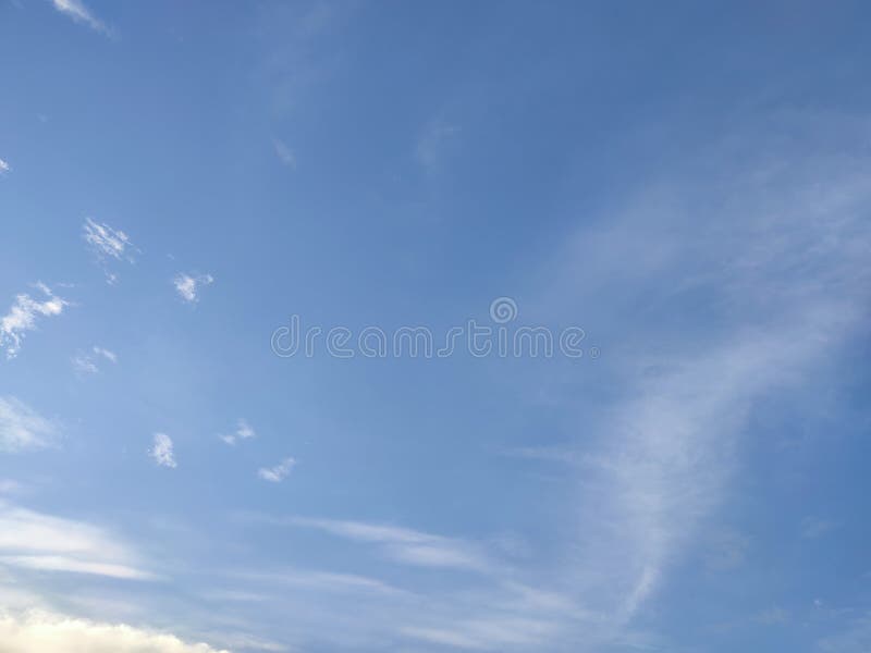 Clear blue sky with foggy lite clouds passing royalty free stock photography
