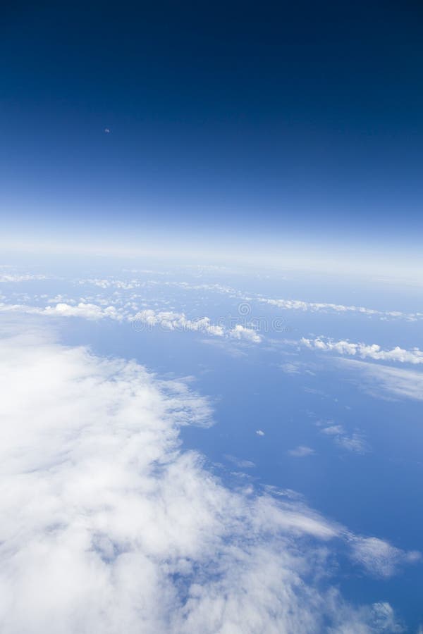 Clear blue sky, moon, Atlantic ocean and clouds view from an air. View from window of an airplane of the moon, blue sky, clouds and Atlantic ocean. Depicts Earth royalty free stock images Clear blue sky, moon, Atlantic ocean and clouds view from an air. View from window of an airplane of the moon, blue sky, clouds and Atlantic ocean. Depicts Earth royalty free stock images
