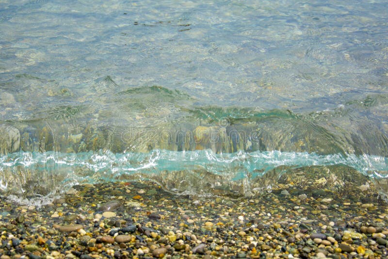 Clear, clean sea wave rolls onto a pebble beach royalty free stock photo Clear, clean sea wave rolls onto a pebble beach royalty free stock photo