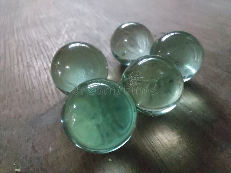 Clear marbles on the desk stock photo. Image of clear 262362942