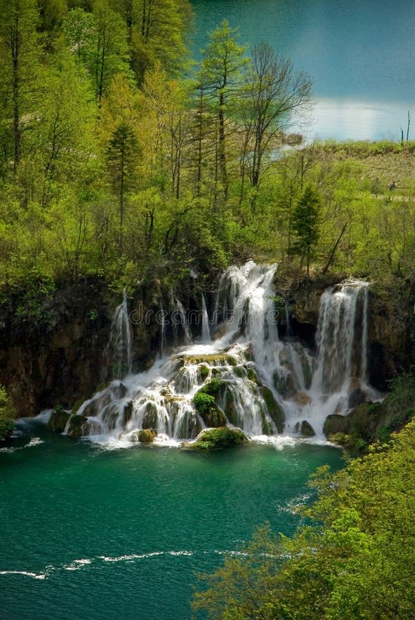 Clear mountain lakes with waterfall in forest