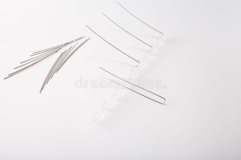 Clear plastic base with metal rods arranged to form bird deterrent segment. Layout demonstrates assembly for specific stock photography