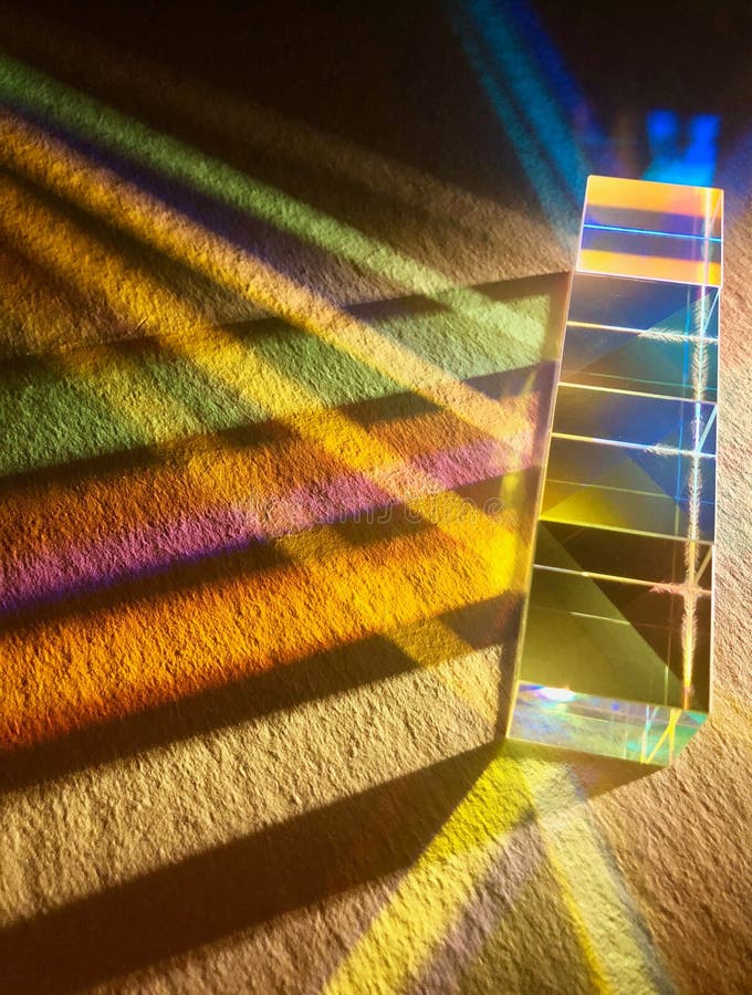 Clear square dichroic glass cubes spreading beam of light into many color spectrums.