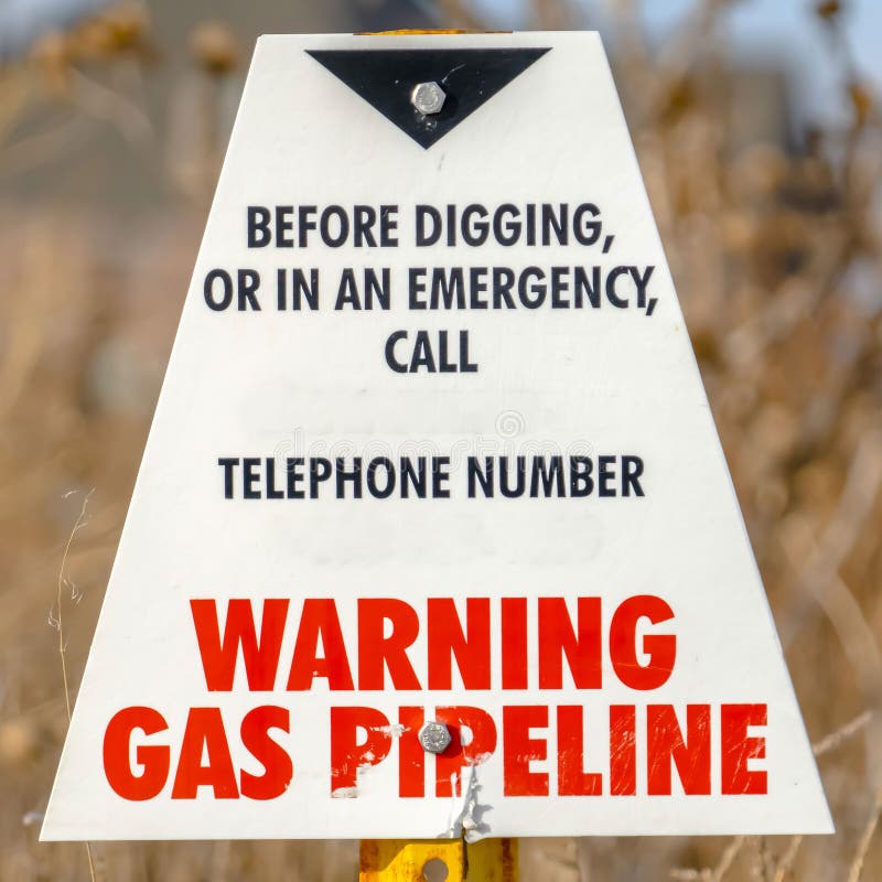 Clear Square Warning sign on an area with gas pipeline with trees and sky in the background royalty free stock images Clear Square Warning sign on an area with gas pipeline with trees and sky in the background royalty free stock images