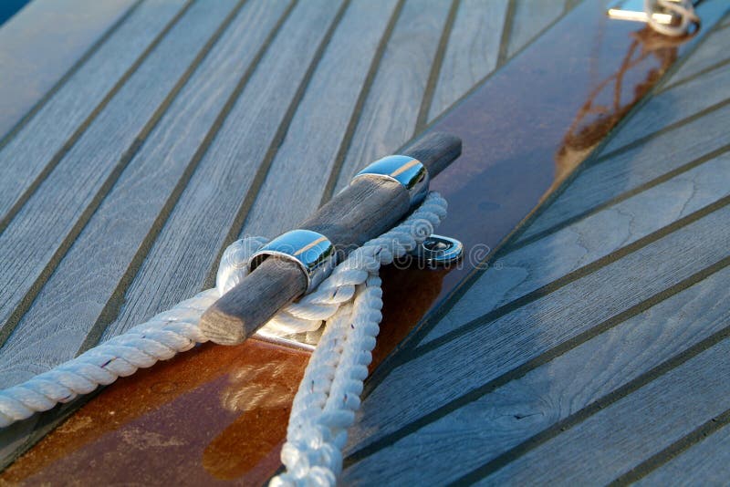 Cleat and rope on a wooden sailboat