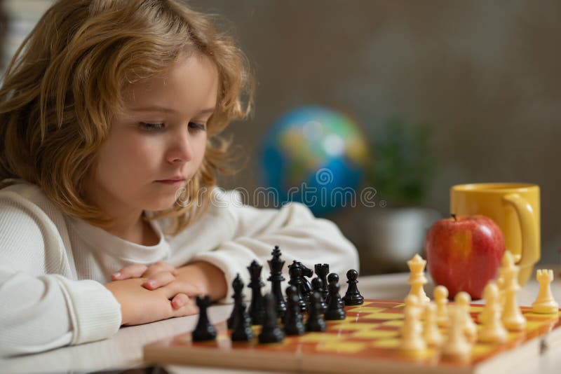 Pupil Kid Thinking About His Next Move In A Game Of Chess. Clever  Concentrated And Thinking Child While Playing Chess. Little Clever Boy  Thinking About Chess. Games Good For Brain Intelligence. Stock