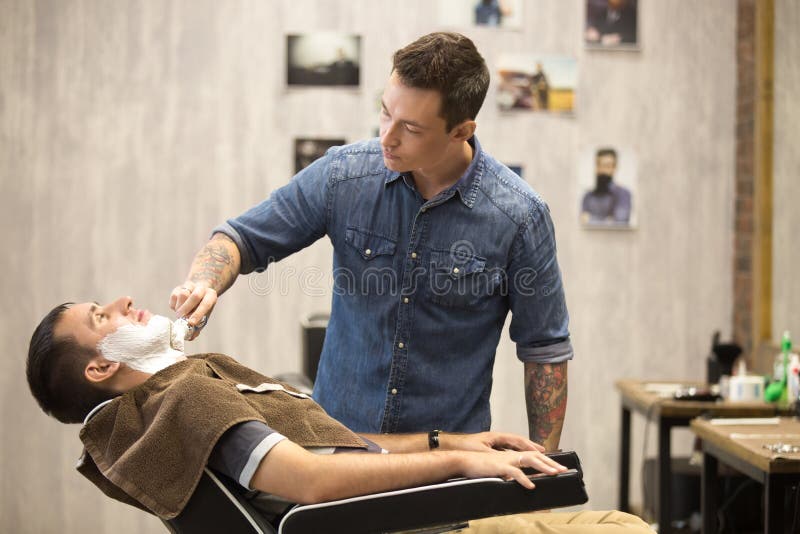 Client Getting Beard Shaving In Barber Shop Stock Photo 