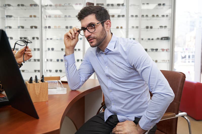 Client Looking at His Face in Mirror with Glasses on Stock Photo ...