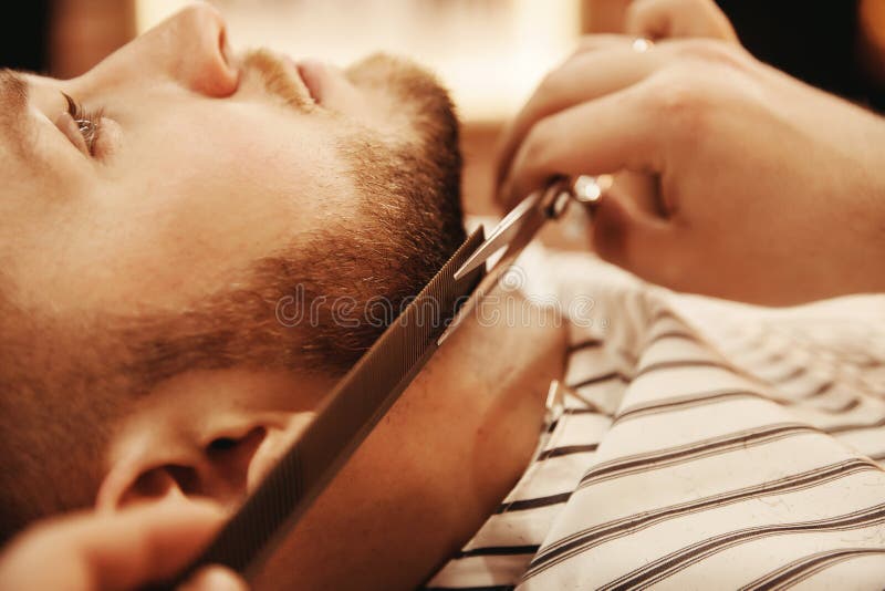 Client is male hipster caring for beard in barbershop. Shave hair royalty free stock photography Client is male hipster caring for beard in barbershop. Shave hair royalty free stock photography