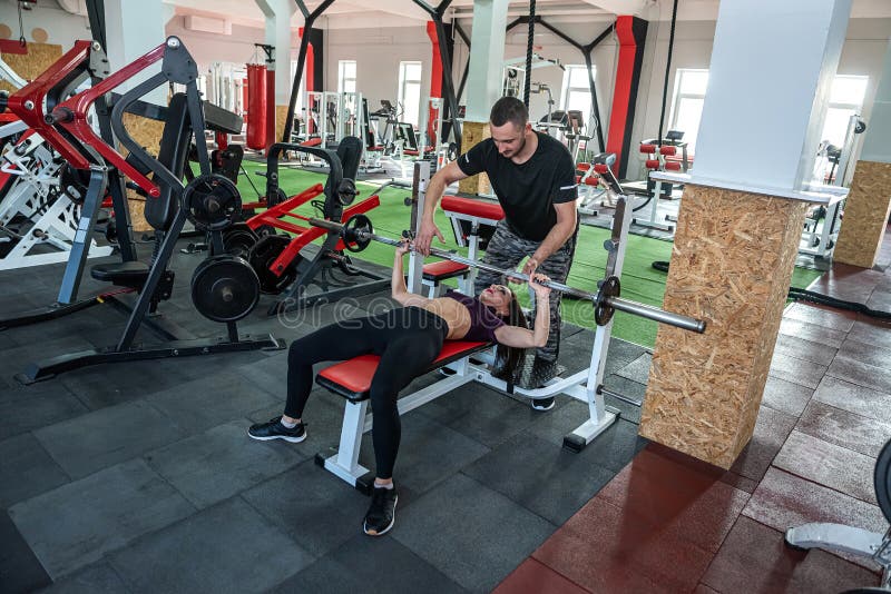 Client With Poersonal Trainer Doing Workout At Gym Stock Image Image