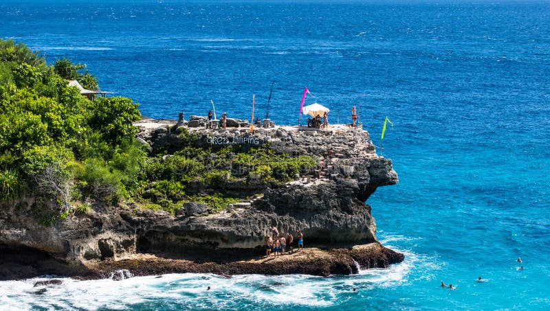 Cliff jumping area. People jumping to the water and relaxing on the beach. Nusa Ceningan, Indonesia