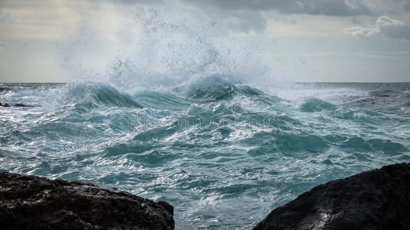 Clima de tempestade no mar As ondas grandes golpeiam contra a água pouco profunda