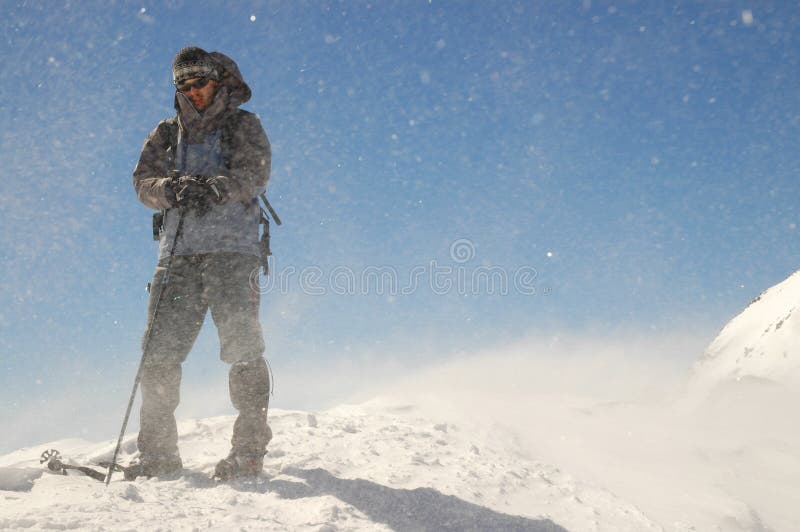 Climber facing wind and snow