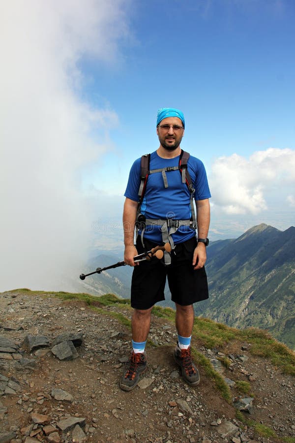 Climber portrait - man on the highest peek in the mountains - in Fagaras Mountains. Rea trail stock images, royalty-free photos and pictures