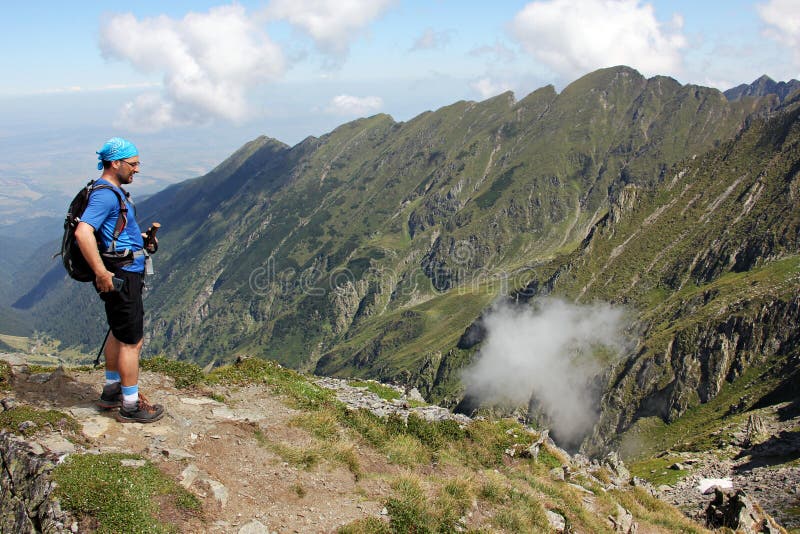 Climber portrait - man on the highest peek in the mountains - in Fagaras Mountains. Rea trail stock images, royalty-free photos and pictures