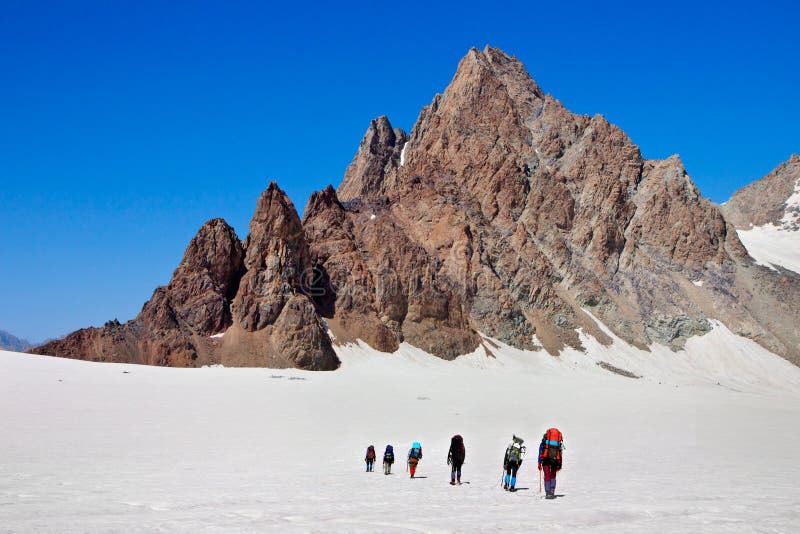 Climbers walk up to the top of the mountain. Climbers walk up to the top of the mountain