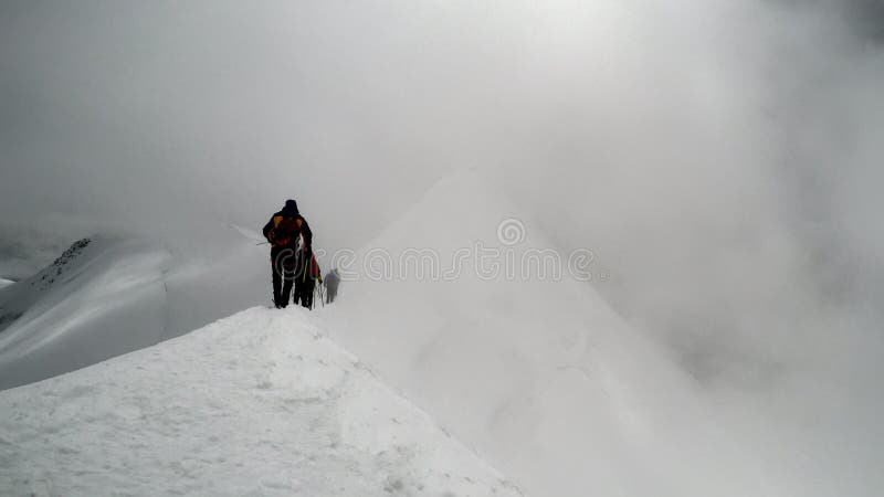 A climbers reaching the summit of the mountain royalty free stock image A climbers reaching the summit of the mountain royalty free stock image