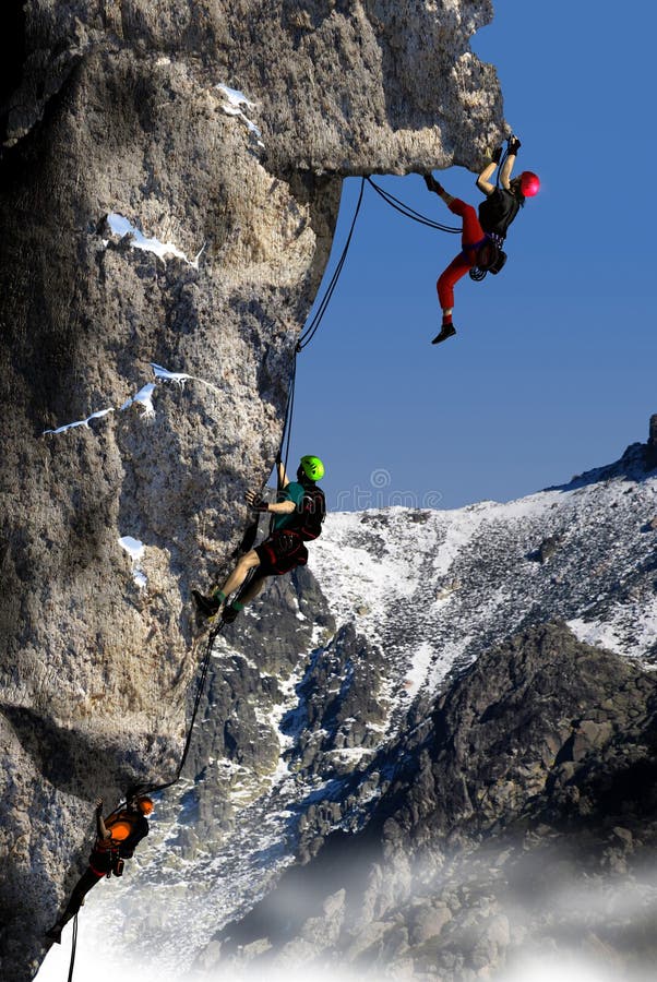 Three persons, a woman first and two men after her, climbing a high rocky mountain in the foreground of snowy hillsides. Three persons, a woman first and two men after her, climbing a high rocky mountain in the foreground of snowy hillsides.