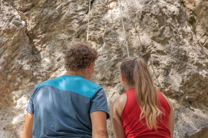 Climbing instructor showing and explaining the route to female climbing beginner stock photo